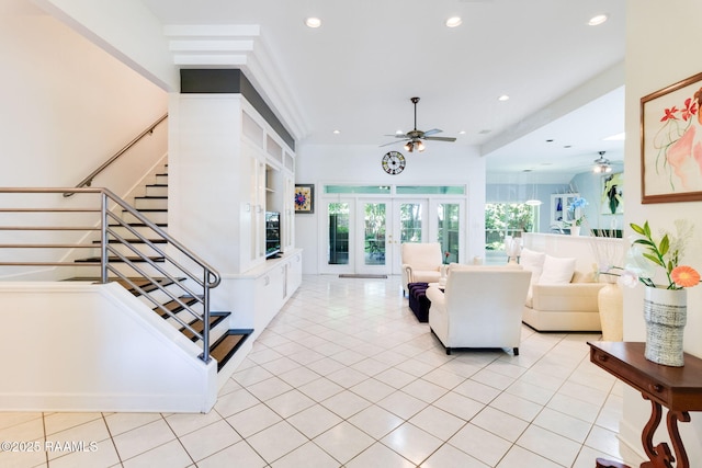 living room with light tile patterned flooring, ceiling fan, and french doors