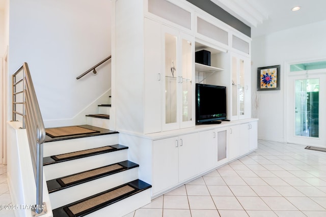 stairway featuring tile patterned flooring