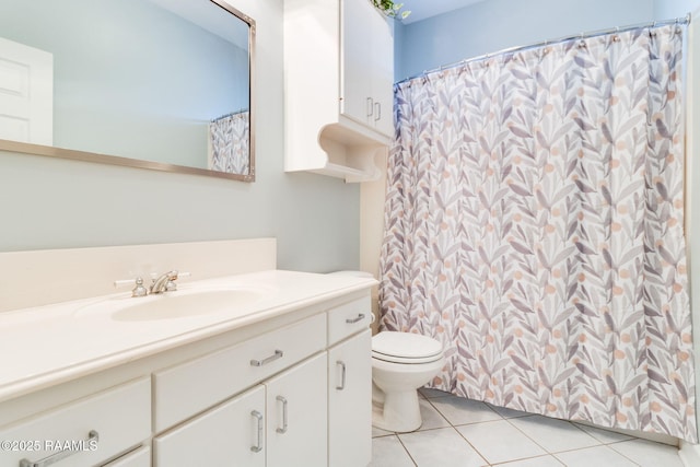 bathroom featuring tile patterned flooring, vanity, and toilet