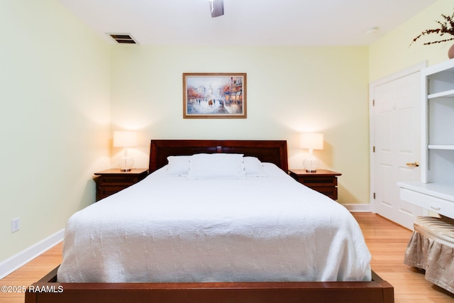 bedroom with light hardwood / wood-style floors and ceiling fan