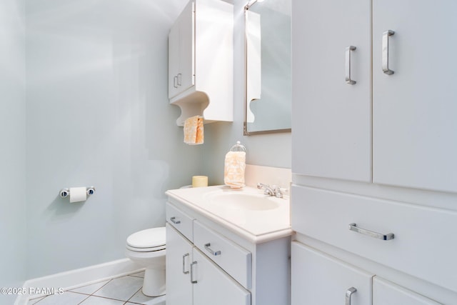 bathroom with tile patterned flooring, vanity, and toilet