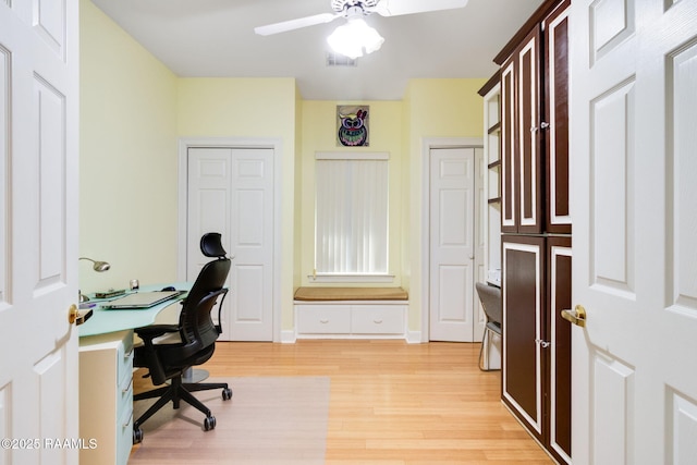 home office with ceiling fan and light wood-type flooring