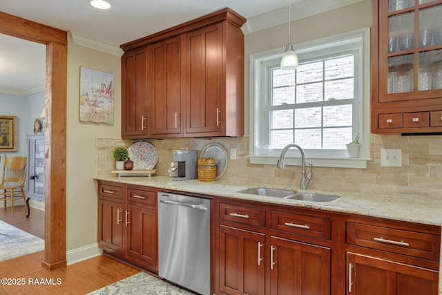 kitchen featuring sink, ornamental molding, stainless steel dishwasher, and light stone countertops