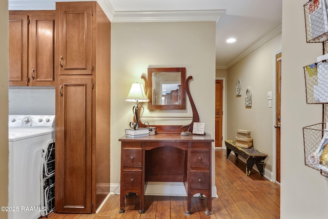 office area with crown molding, washer / dryer, and light wood-type flooring