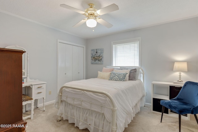 carpeted bedroom with crown molding, a textured ceiling, a closet, and ceiling fan