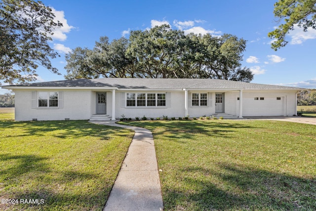 ranch-style house with a garage and a front lawn