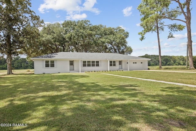 ranch-style house with a garage and a front yard