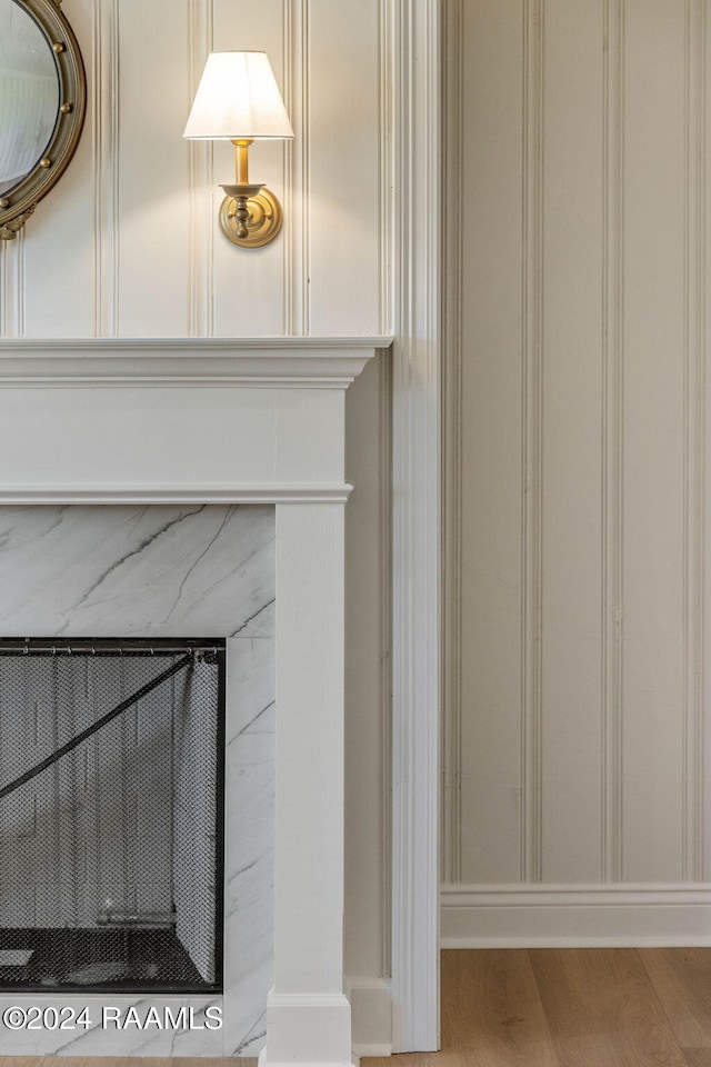 room details featuring a high end fireplace and wood-type flooring