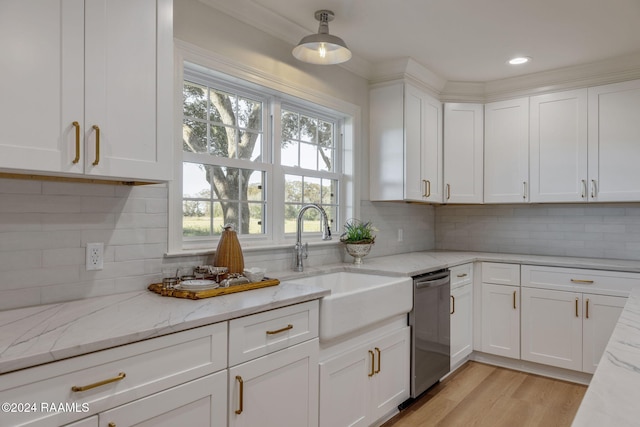 kitchen with light stone counters, decorative light fixtures, dishwasher, and white cabinets