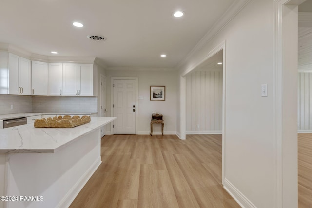 kitchen with dishwasher, white cabinetry, backsplash, light stone countertops, and light wood-type flooring