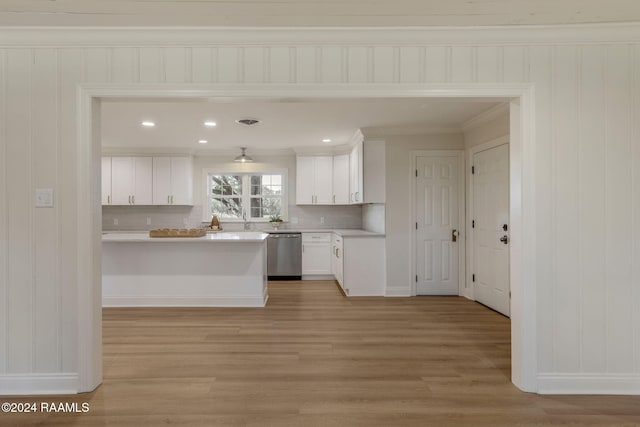 kitchen with dishwasher, white cabinets, light hardwood / wood-style floors, and decorative backsplash