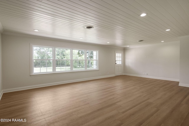 unfurnished room featuring hardwood / wood-style flooring, ornamental molding, and wooden ceiling