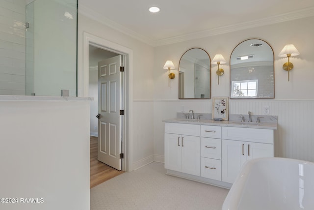 bathroom with crown molding, a bath, and vanity