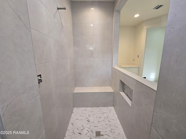 bathroom with a tile shower