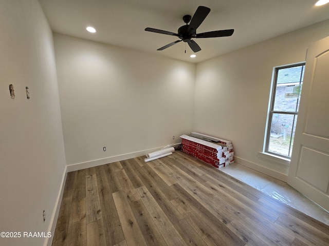 spare room featuring hardwood / wood-style floors and ceiling fan