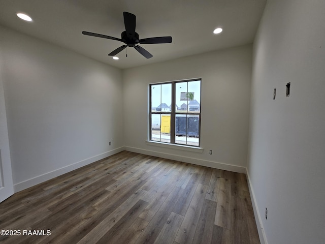 spare room featuring hardwood / wood-style flooring and ceiling fan