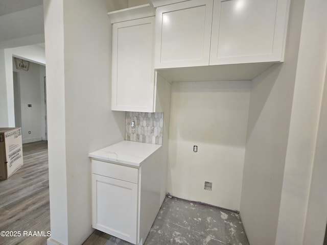 laundry room with wood-type flooring