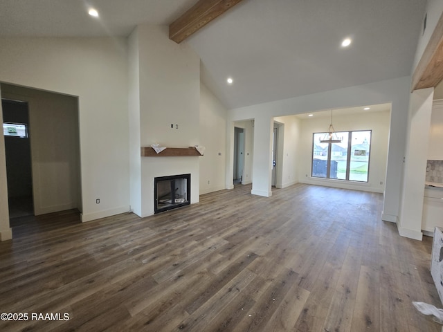 unfurnished living room featuring hardwood / wood-style floors, high vaulted ceiling, and beamed ceiling