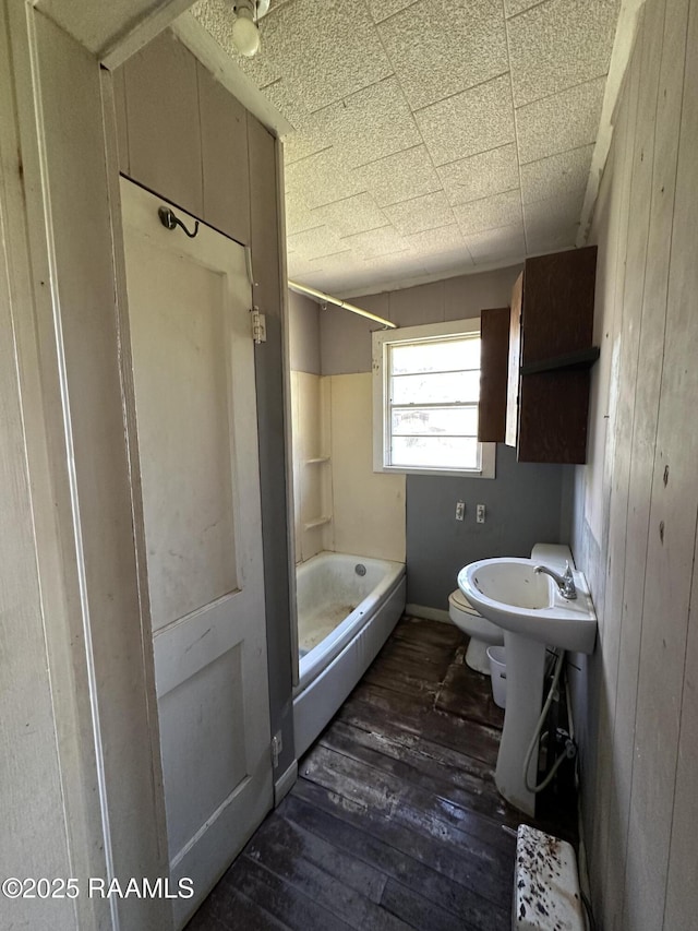 518 Buller Rd, Ville Platte, LA 70586 - full bathroom with toilet, bathtub / shower combination, and hardwood / wood-style flooring
