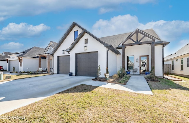 view of front of house featuring a garage and a front lawn