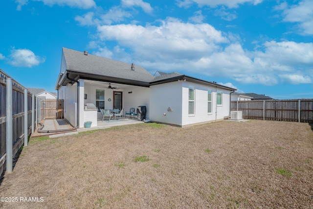 rear view of house with central AC unit, a yard, a patio area, and ceiling fan