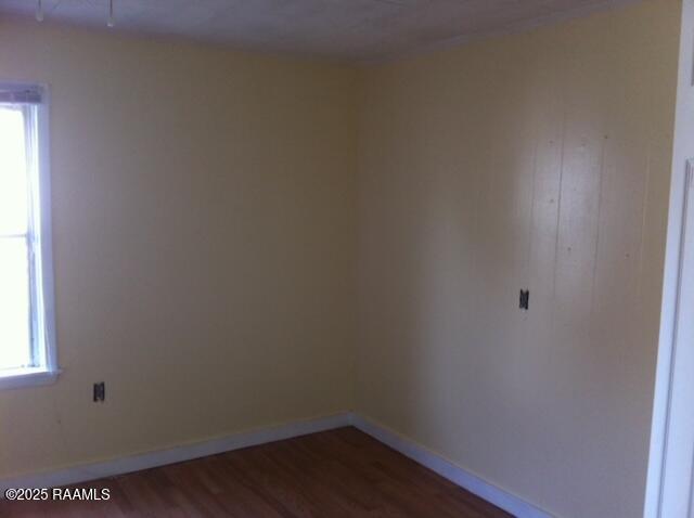 empty room with dark wood-type flooring