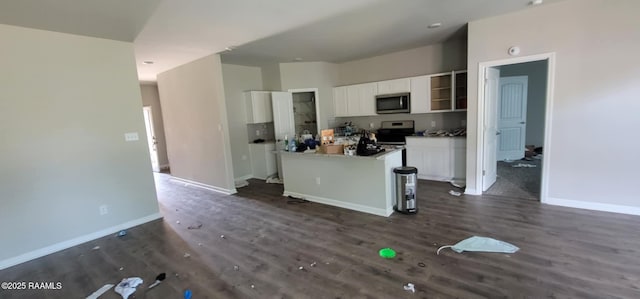 kitchen with dark hardwood / wood-style flooring, stainless steel appliances, a breakfast bar, and white cabinets