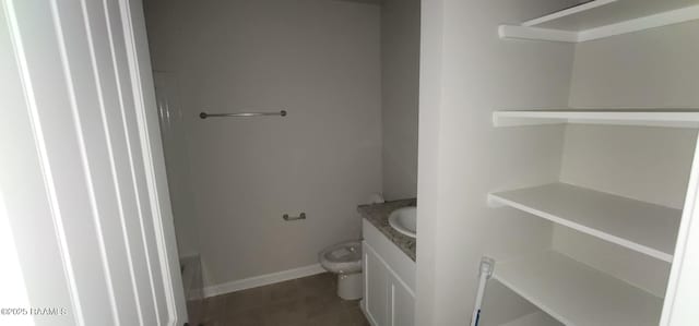 bathroom with tile patterned flooring, vanity, and toilet