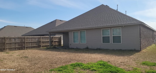 back of house with a lawn