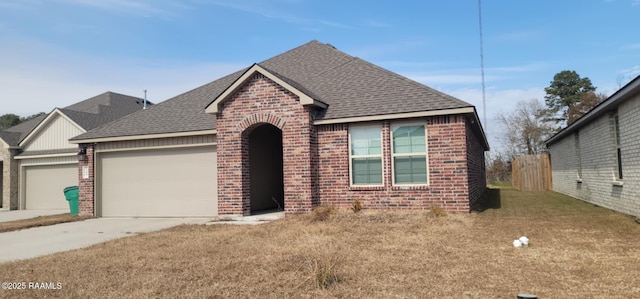 view of front of property with a garage and a front lawn