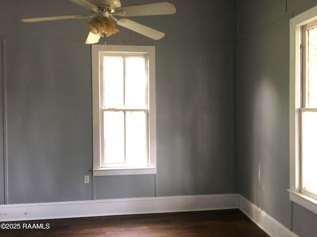 empty room featuring ceiling fan and dark hardwood / wood-style floors