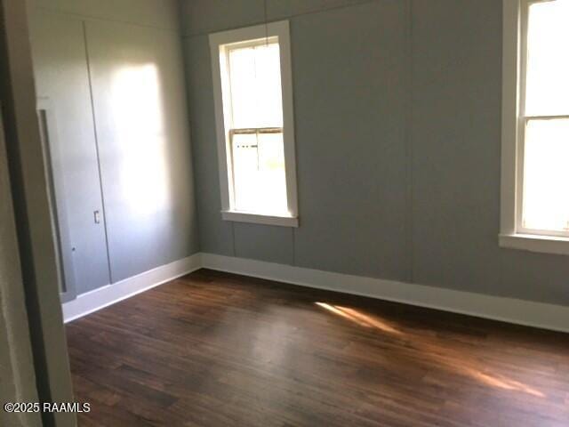 spare room with dark hardwood / wood-style floors