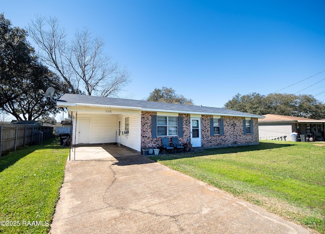 view of front of house with driveway, a front lawn, fence, and brick siding