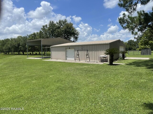 7515 W Congress St, Duson, LA 70529 - view of green lawn featuring a detached garage and an outdoor structure