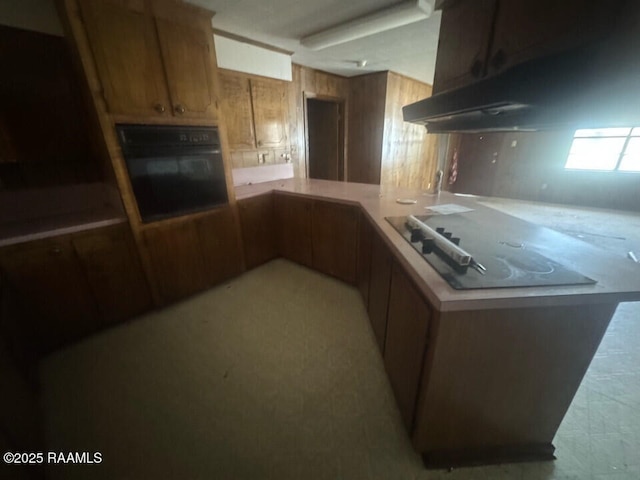 kitchen featuring oven, cooktop, and kitchen peninsula