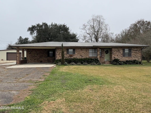 ranch-style home with a carport, a garage, and a front yard