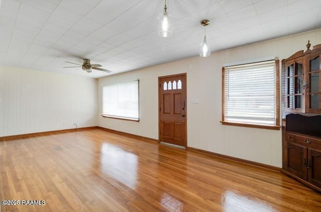 entryway with ceiling fan and light wood-type flooring