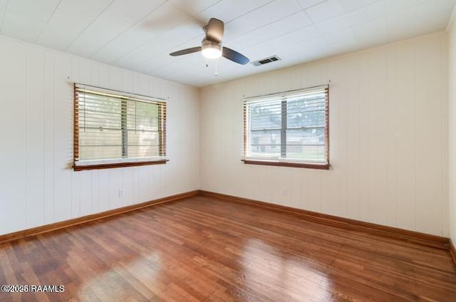 unfurnished room featuring hardwood / wood-style floors and ceiling fan