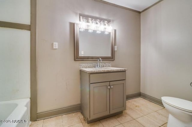 bathroom with tile patterned flooring, vanity, ornamental molding, toilet, and a bathing tub