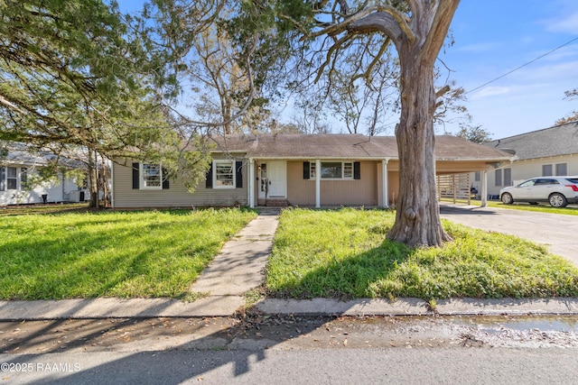 ranch-style house featuring a front lawn and a carport