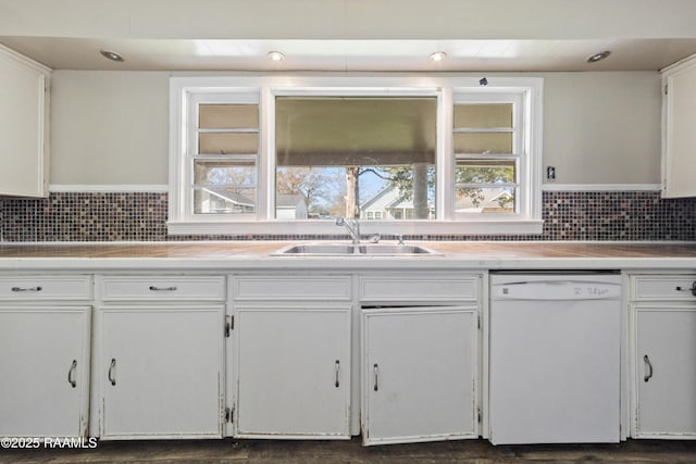 kitchen featuring white cabinetry, sink, backsplash, and dishwasher