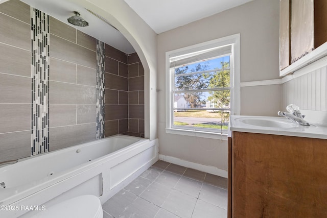 full bathroom with tile patterned flooring, vanity, toilet, and tiled shower / bath