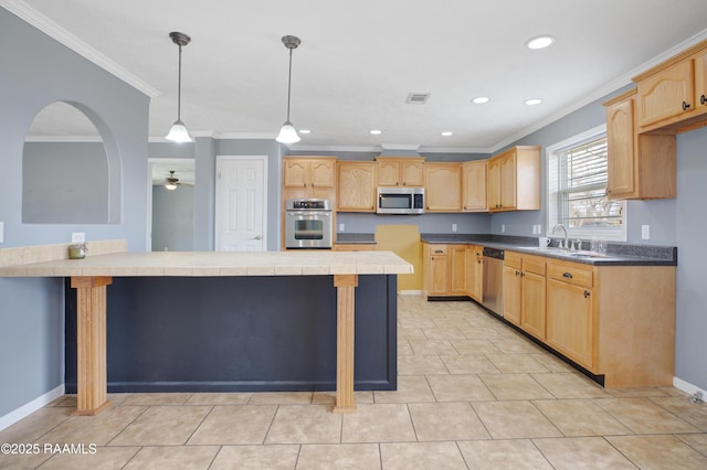 kitchen with hanging light fixtures, stainless steel appliances, a center island, ornamental molding, and light brown cabinetry