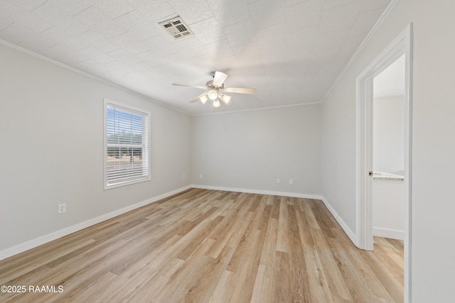 empty room with crown molding, light hardwood / wood-style floors, and ceiling fan