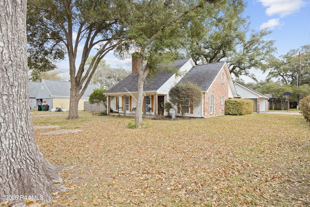 view of front of house with a garage, a front lawn, and a porch