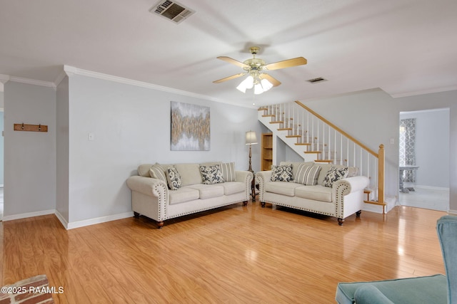 living room featuring hardwood / wood-style flooring, crown molding, and ceiling fan