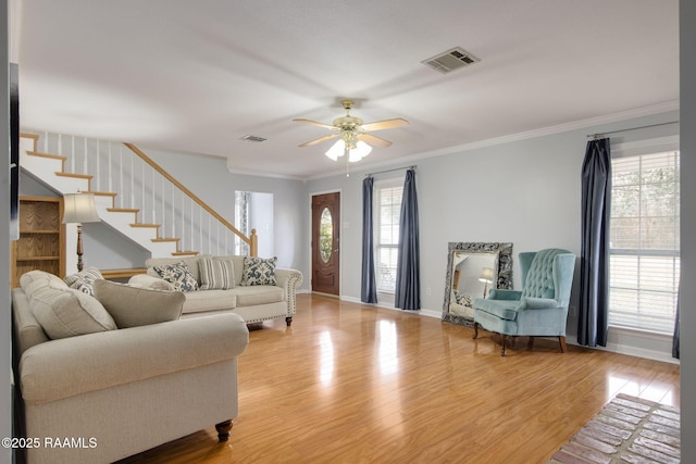 living room featuring ornamental molding, ceiling fan, and light hardwood / wood-style flooring