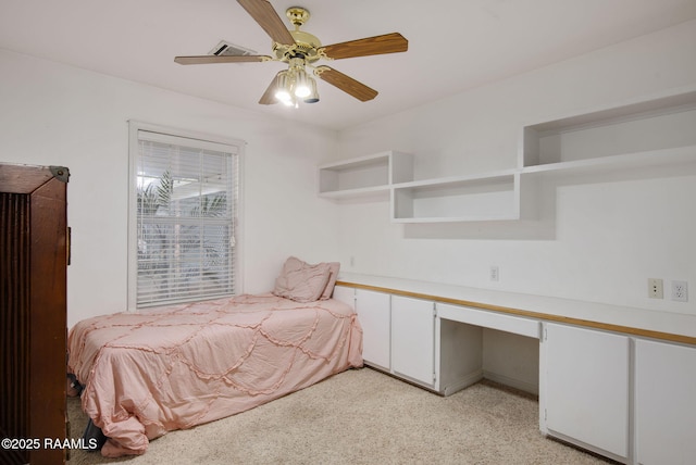 unfurnished bedroom featuring built in desk and ceiling fan