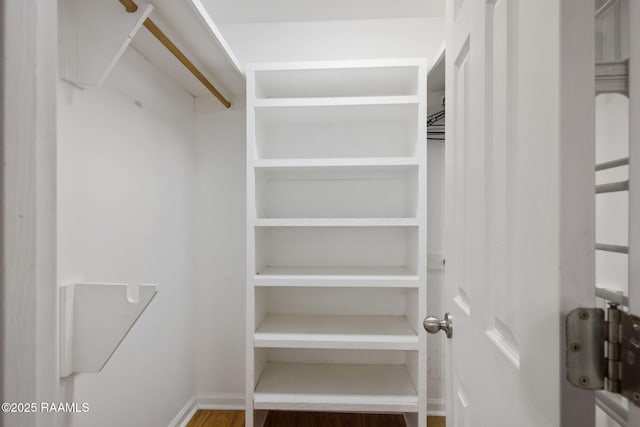 walk in closet featuring hardwood / wood-style floors