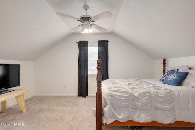 carpeted bedroom featuring ceiling fan and vaulted ceiling